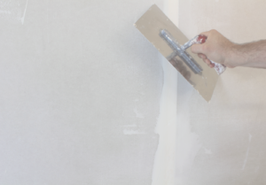 Feathering drywall joint with trowel